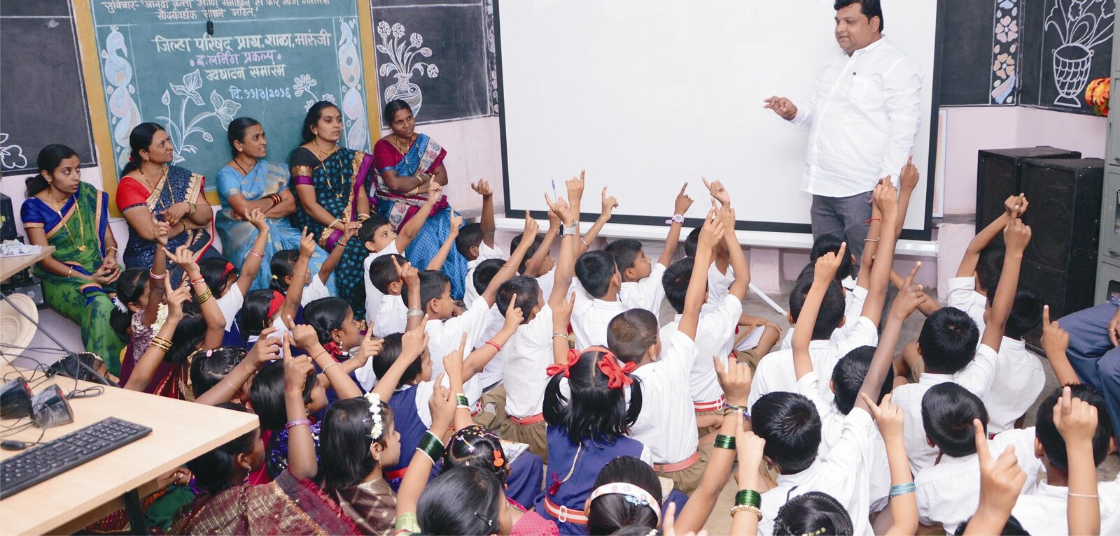 Teachers and students with hands raised during a Global Classroom session.